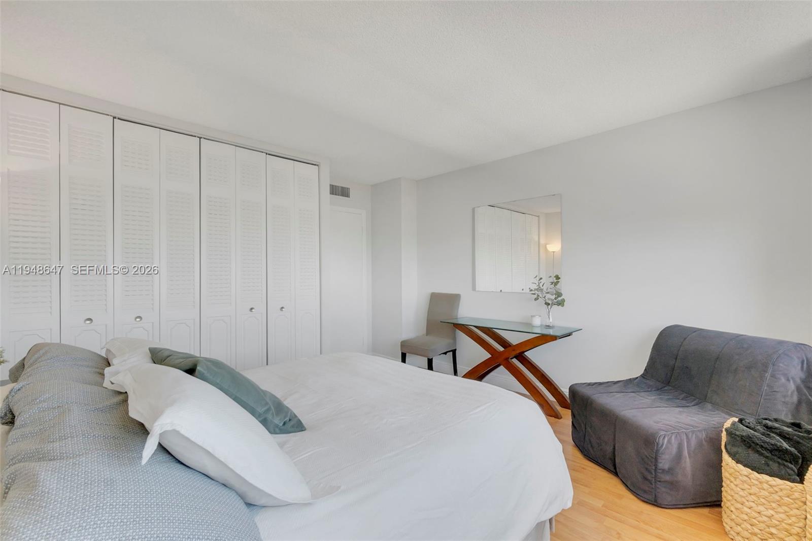 2121 North Ocean Boulevard, Unit 902W Boca Raton, FL 33431 - Photo 28 of 62 a bedroom with a bed and wooden floor