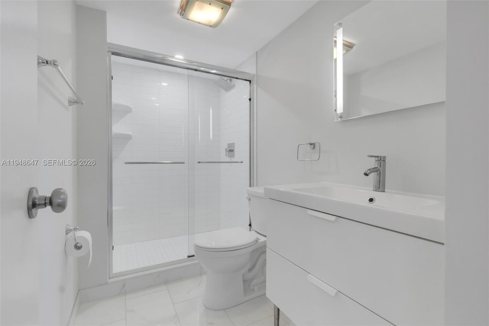 2121 North Ocean Boulevard, Unit 902W Boca Raton, FL 33431 - Photo 31 of 62 a bathroom with a shower a toilet and a sink