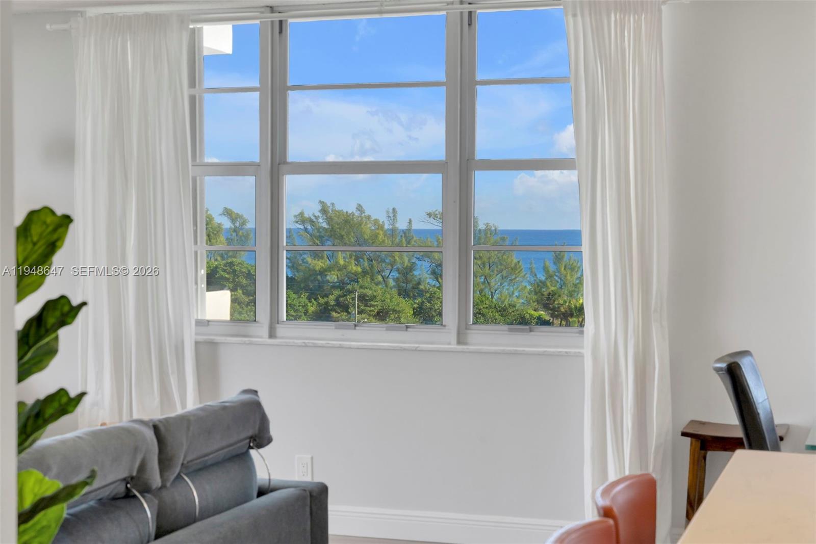 2121 North Ocean Boulevard, Unit 902W Boca Raton, FL 33431 - Photo 32 of 62 a living room with furniture and a window