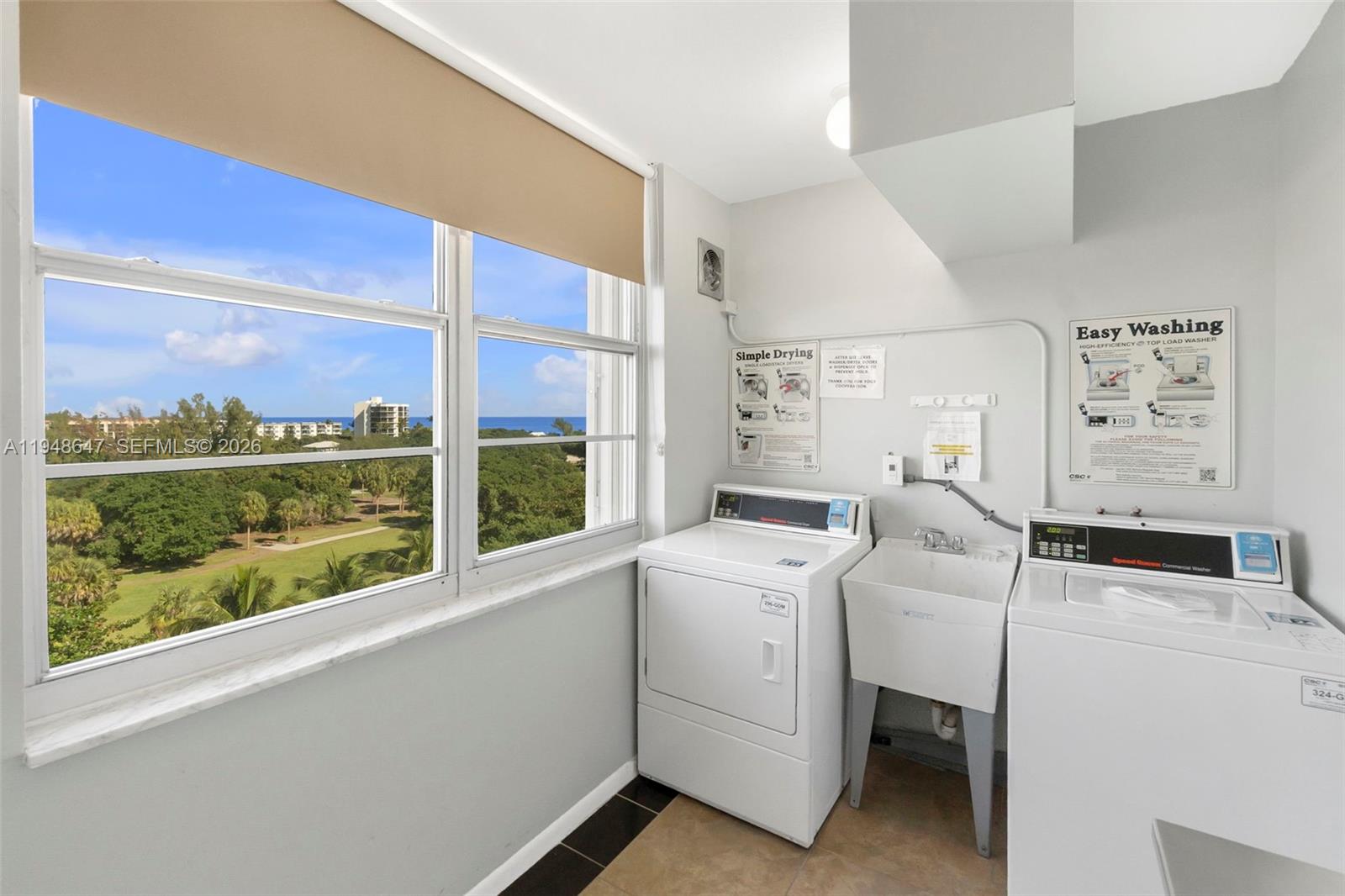 2121 North Ocean Boulevard, Unit 902W Boca Raton, FL 33431 - Photo 36 of 62 a view of washer and dryer with bathroom in the background