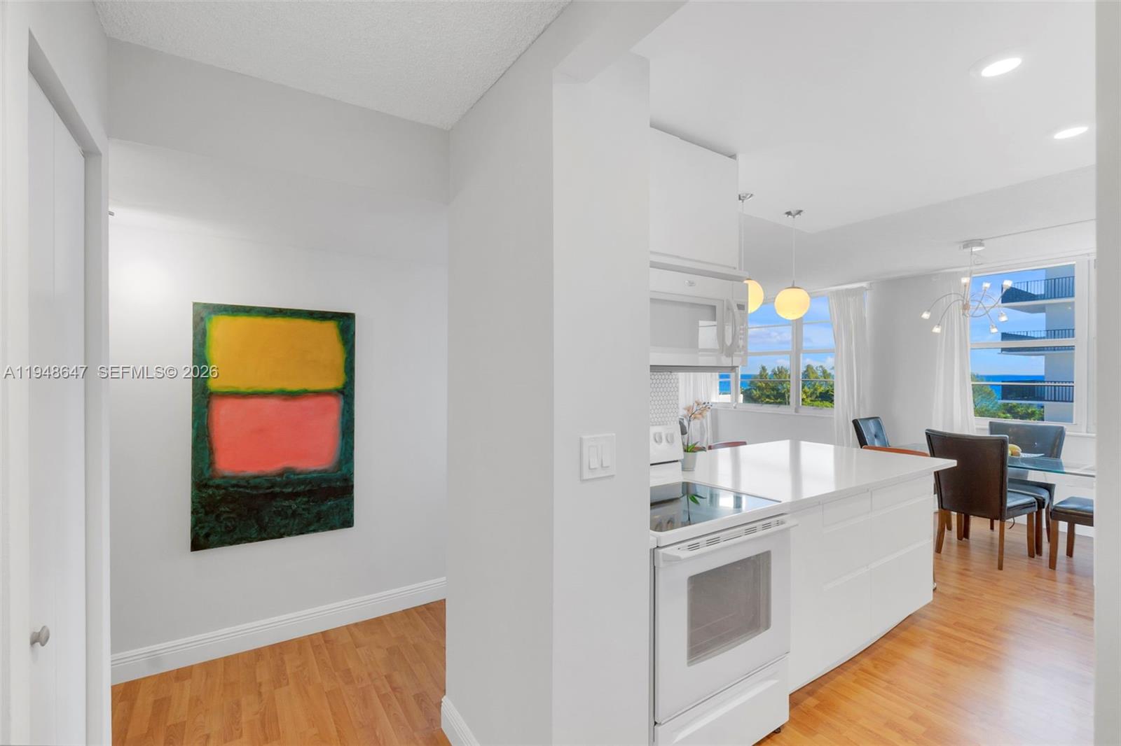 2121 North Ocean Boulevard, Unit 902W Boca Raton, FL 33431 - Photo 4 of 62 a living room with stainless steel appliances furniture and a flat screen tv
