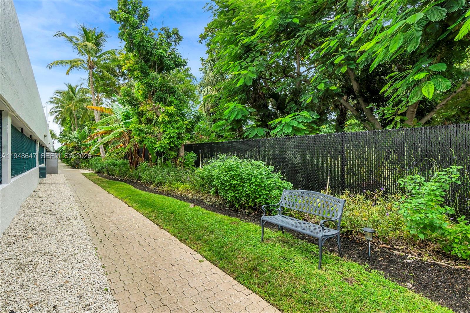 2121 North Ocean Boulevard, Unit 902W Boca Raton, FL 33431 - Photo 43 of 62 a view of a garden with a bench