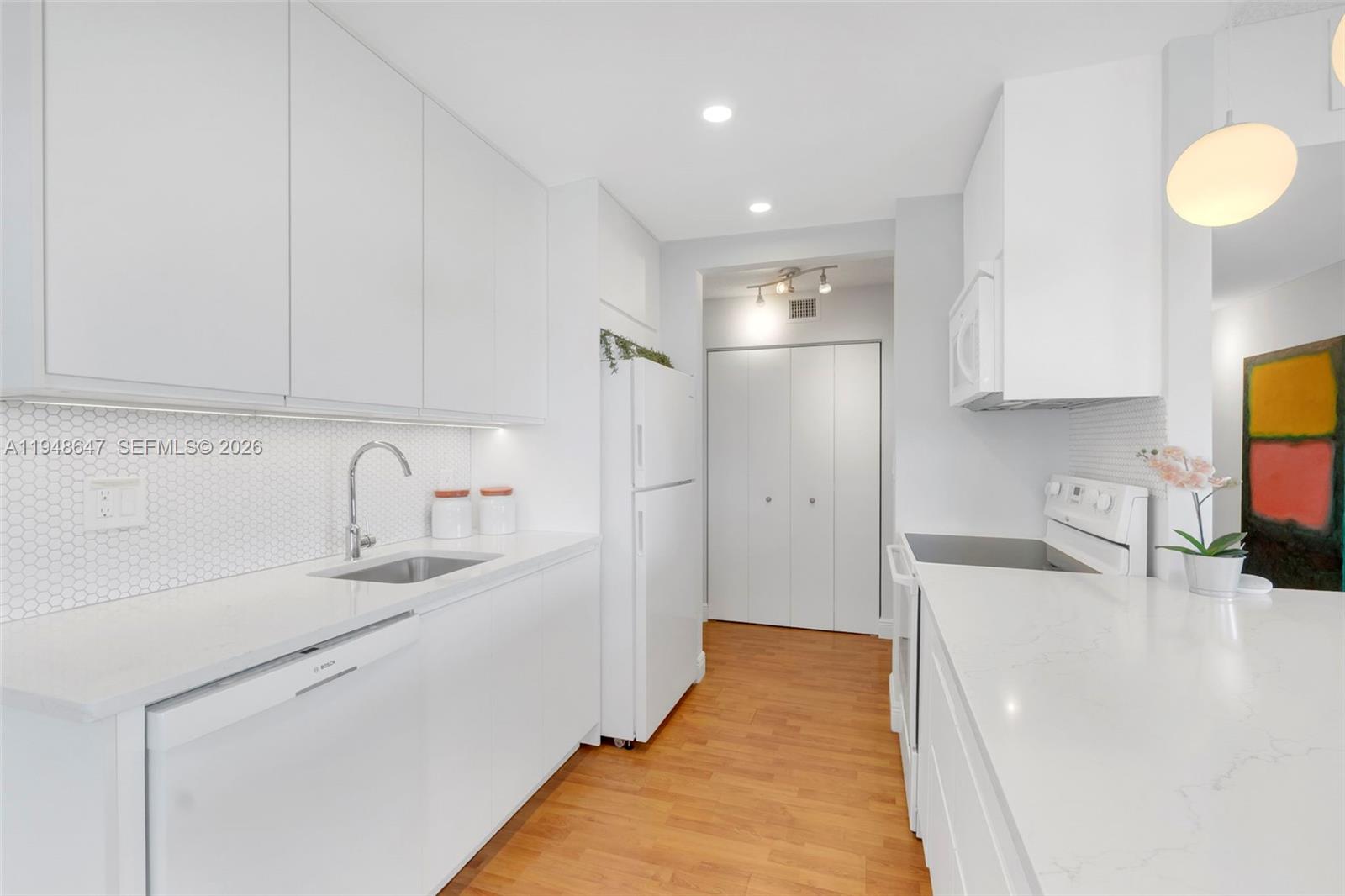 2121 North Ocean Boulevard, Unit 902W Boca Raton, FL 33431 - Photo 5 of 62 a kitchen with stainless steel appliances granite countertop a sink and a refrigerator