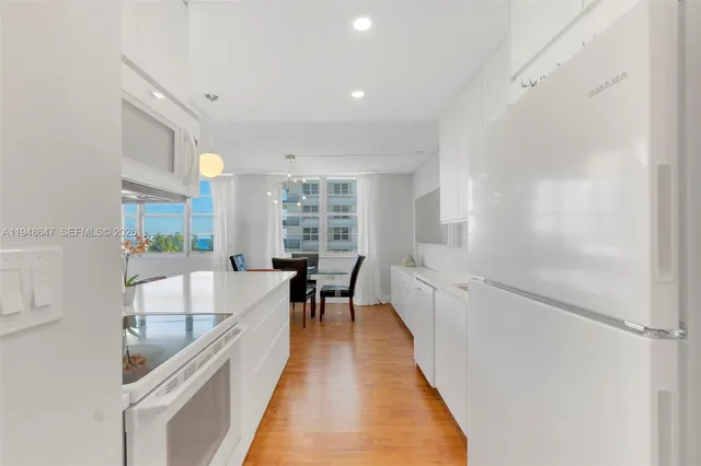 a dining room with furniture and a kitchen view