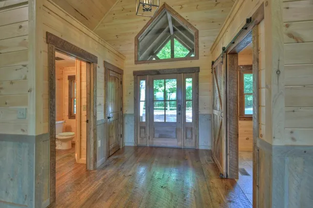 a view of an empty room with window and fire place