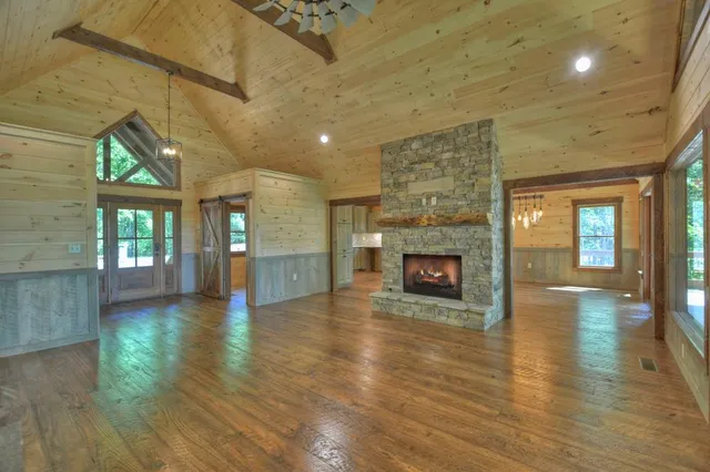 a bathroom with a granite countertop toilet a sink and a window