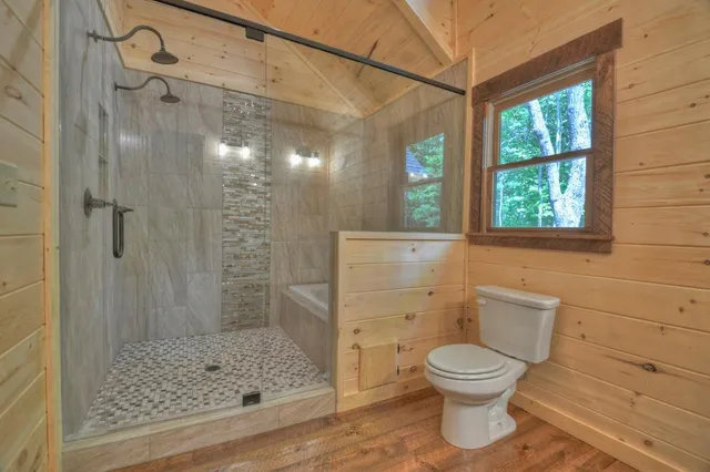 a bathroom with a granite countertop sink a mirror and a shower