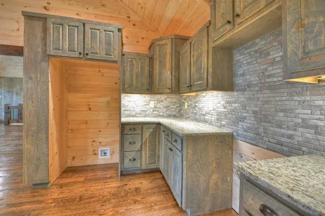 a bathroom with a granite countertop sink a mirror and a shower