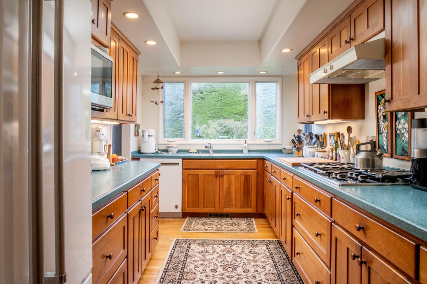 26140 Mesa Drive Carmel, CA 93923 - Photo 7 of 18 a kitchen with stainless steel appliances granite countertop a sink and a stove