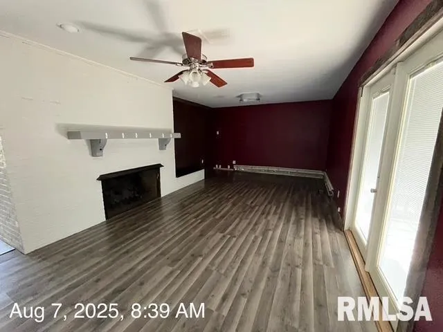 a view of a hallway with wooden floor and closet