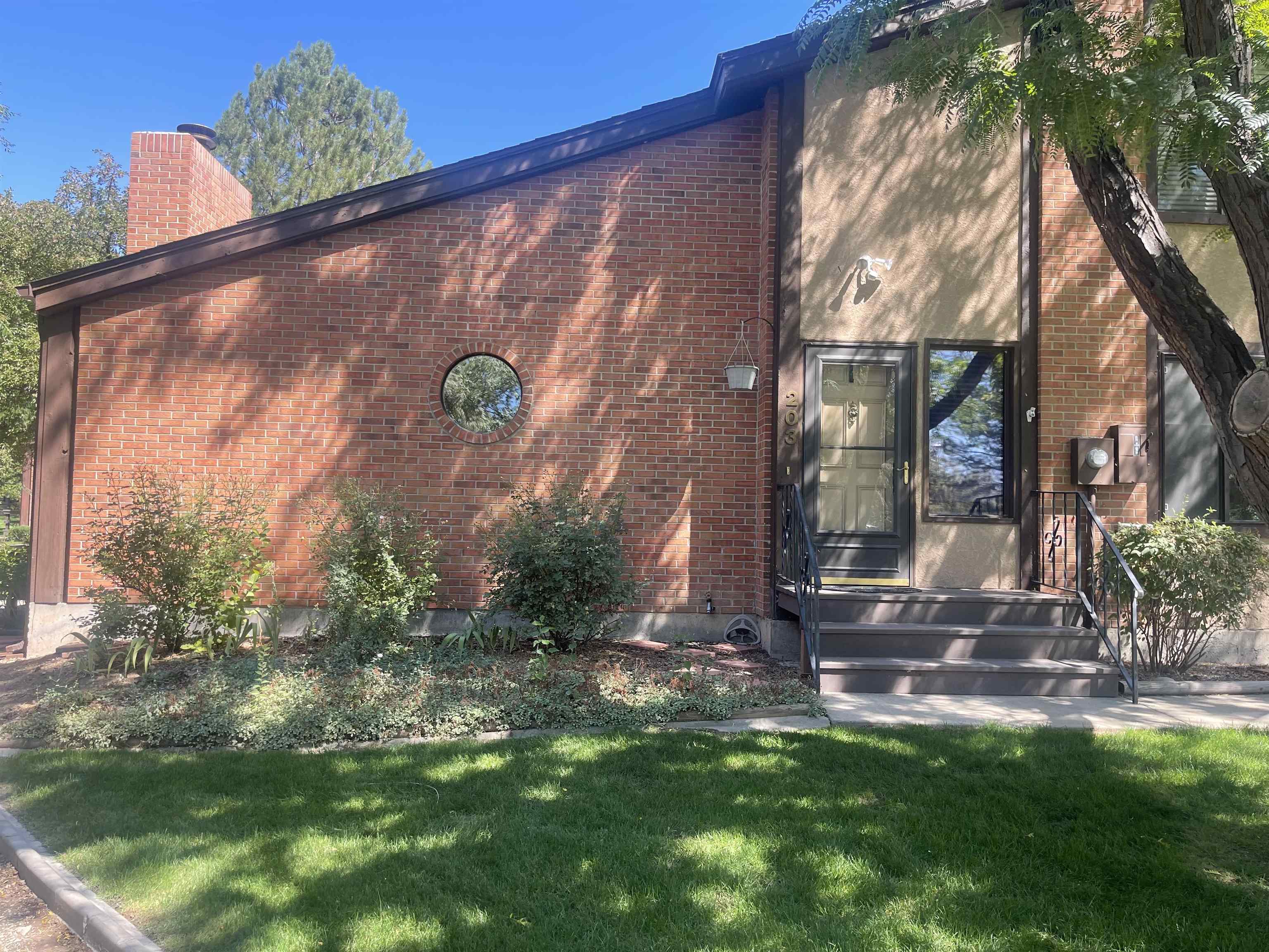 636 Horizon Drive, Unit 203 Grand Junction, CO 81506 - Photo 1 of 22 a front view of a house with garden