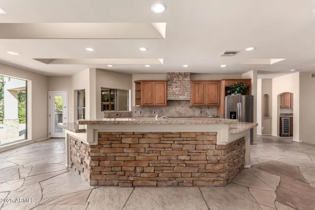 a utility room with granite countertop cabinets washer and dryer