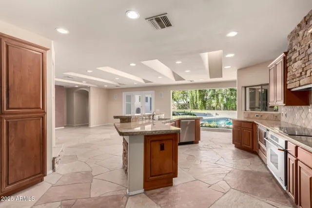 a bathroom with a granite countertop toilet and a sink