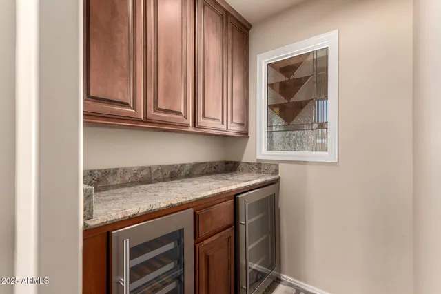 a bathroom with a granite countertop sink mirror and cabinets