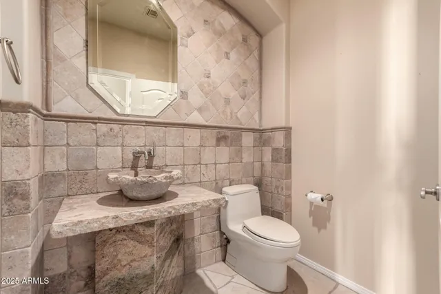 a spacious bathroom with a double vanity sink a mirror and a bathtub