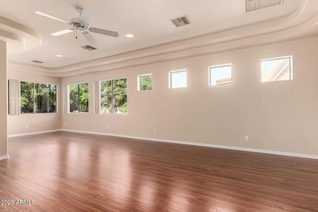 a view of an empty room with closet and mirror