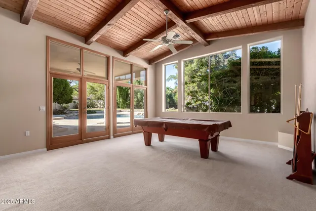 a view of a big room with windows and chandelier