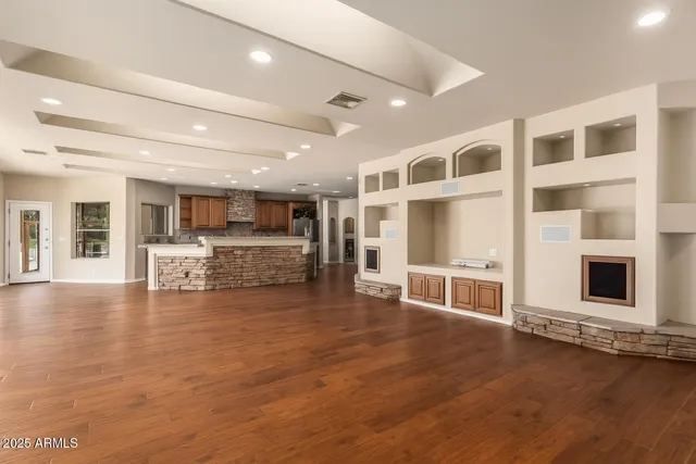 a large kitchen with kitchen island a sink counter top stainless steel appliances and cabinets