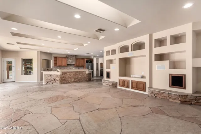 a kitchen with kitchen island granite countertop lots of counter top space and stainless steel appliances