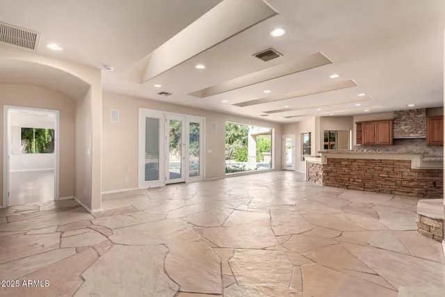 a large kitchen with kitchen island granite countertop a large window and kitchen island