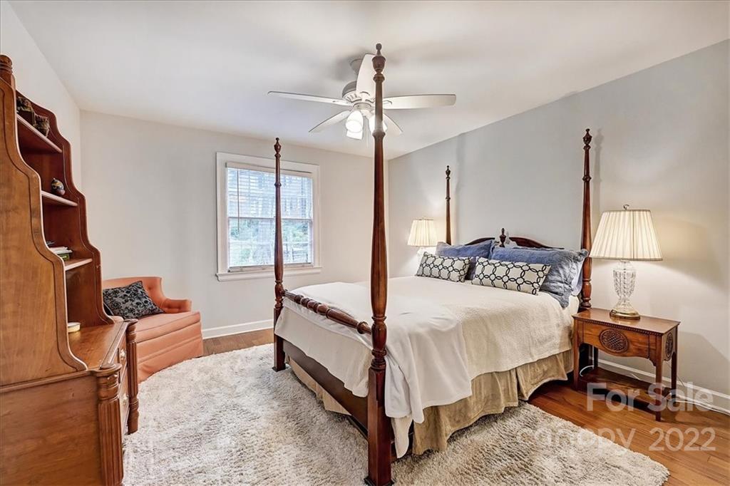 104 Colville Road, Unit 41C Charlotte, NC 28207 - Photo 12 of 22 a bedroom with a bed and wooden floor