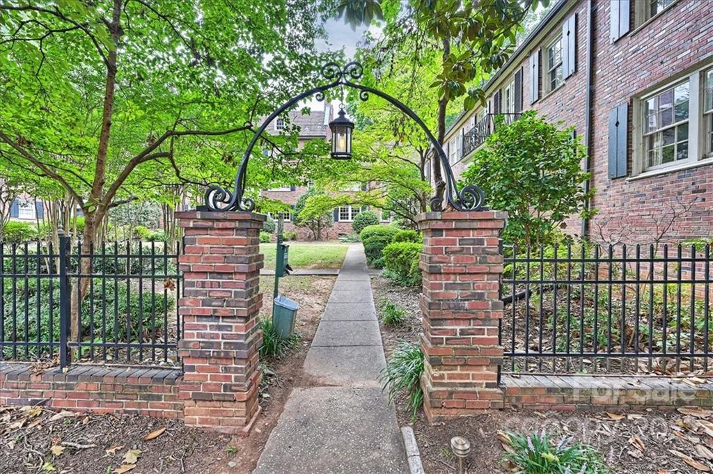 104 Colville Road, Unit 41C Charlotte, NC 28207 - Photo 3 of 22 a front view of a house with a garden