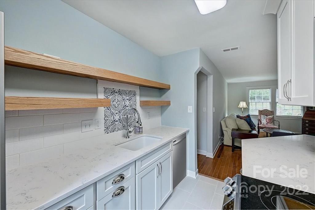 104 Colville Road, Unit 41C Charlotte, NC 28207 - Photo 6 of 22 a kitchen with stainless steel appliances granite countertop a sink dishwasher stove and refrigerator