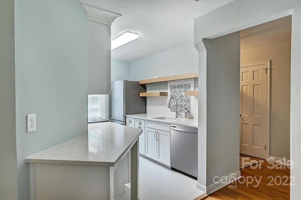 104 Colville Road, Unit 41C Charlotte, NC 28207 - Photo 7 of 22 a kitchen with stainless steel appliances granite countertop a sink stove and refrigerator