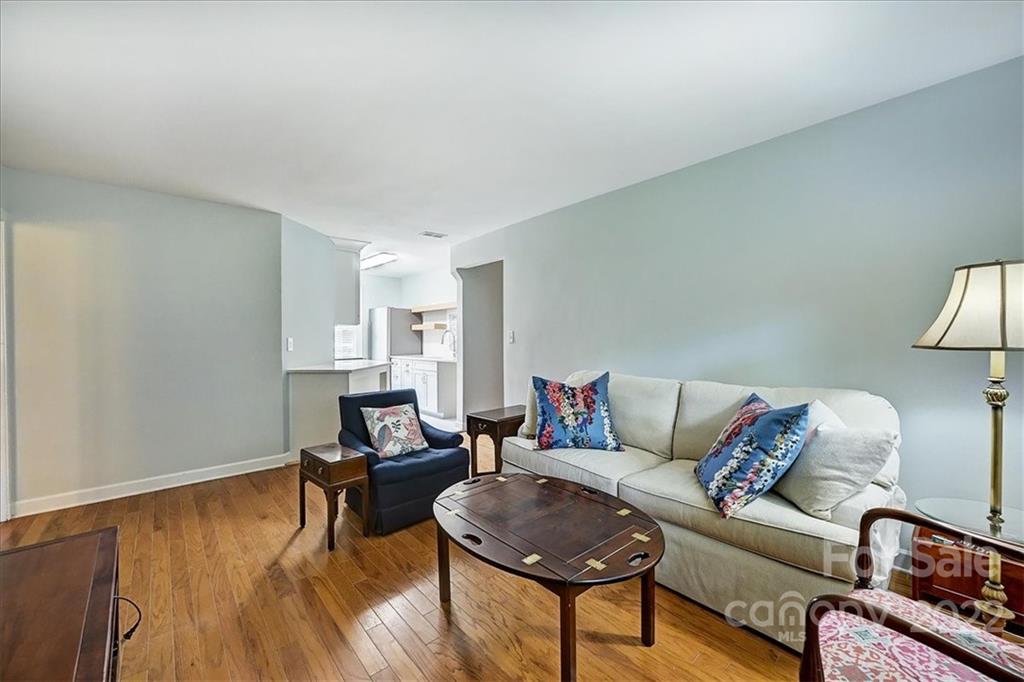 104 Colville Road, Unit 41C Charlotte, NC 28207 - Photo 8 of 22 a living room with furniture and a wooden floor