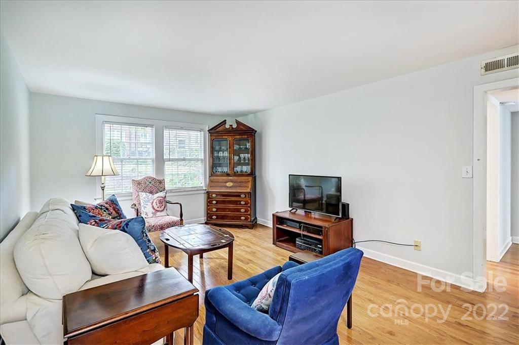 104 Colville Road, Unit 41C Charlotte, NC 28207 - Photo 9 of 22 a living room with furniture a flat screen tv and a window