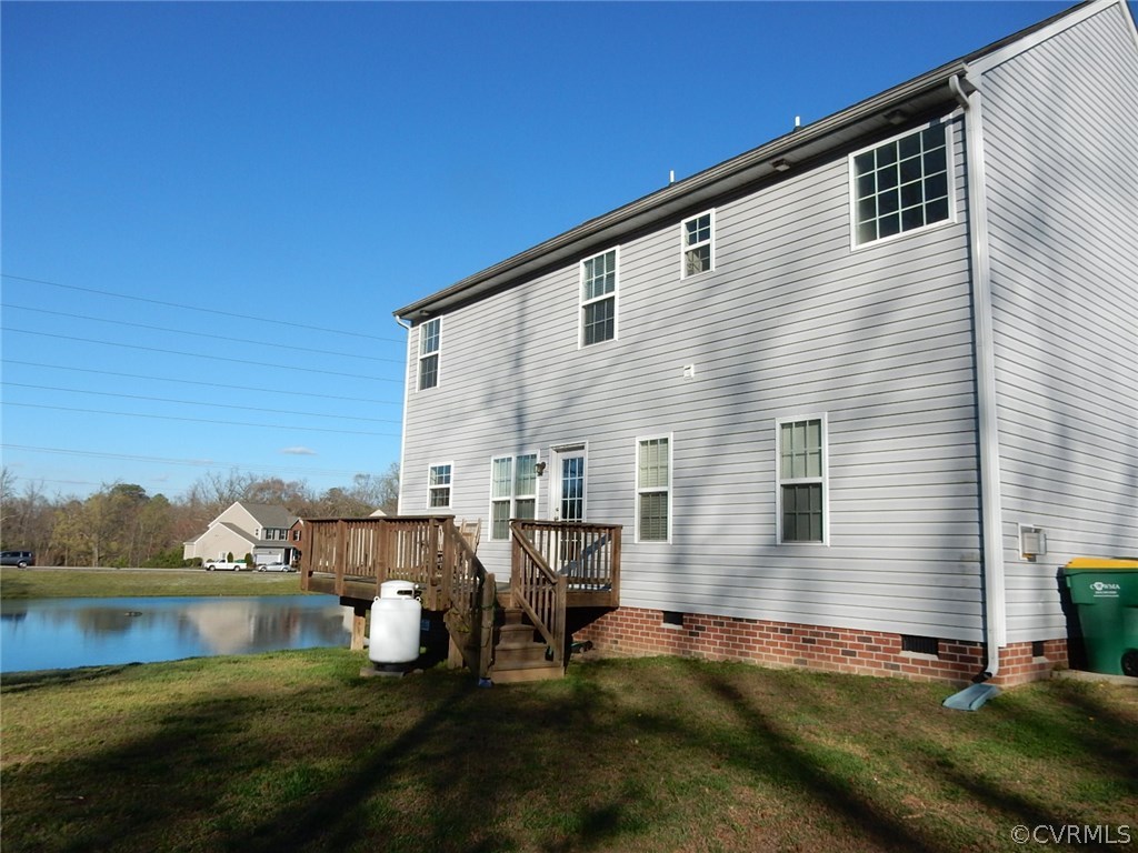 4110 Cameron Road Hopewell, VA 23860 - Photo 5 of 20 a backyard of a house with lake view and a floor to ceiling window