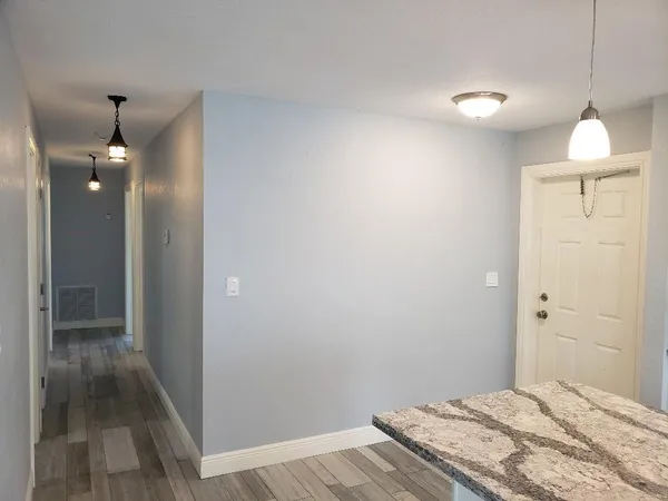 a bedroom with a bed and a chandelier fan