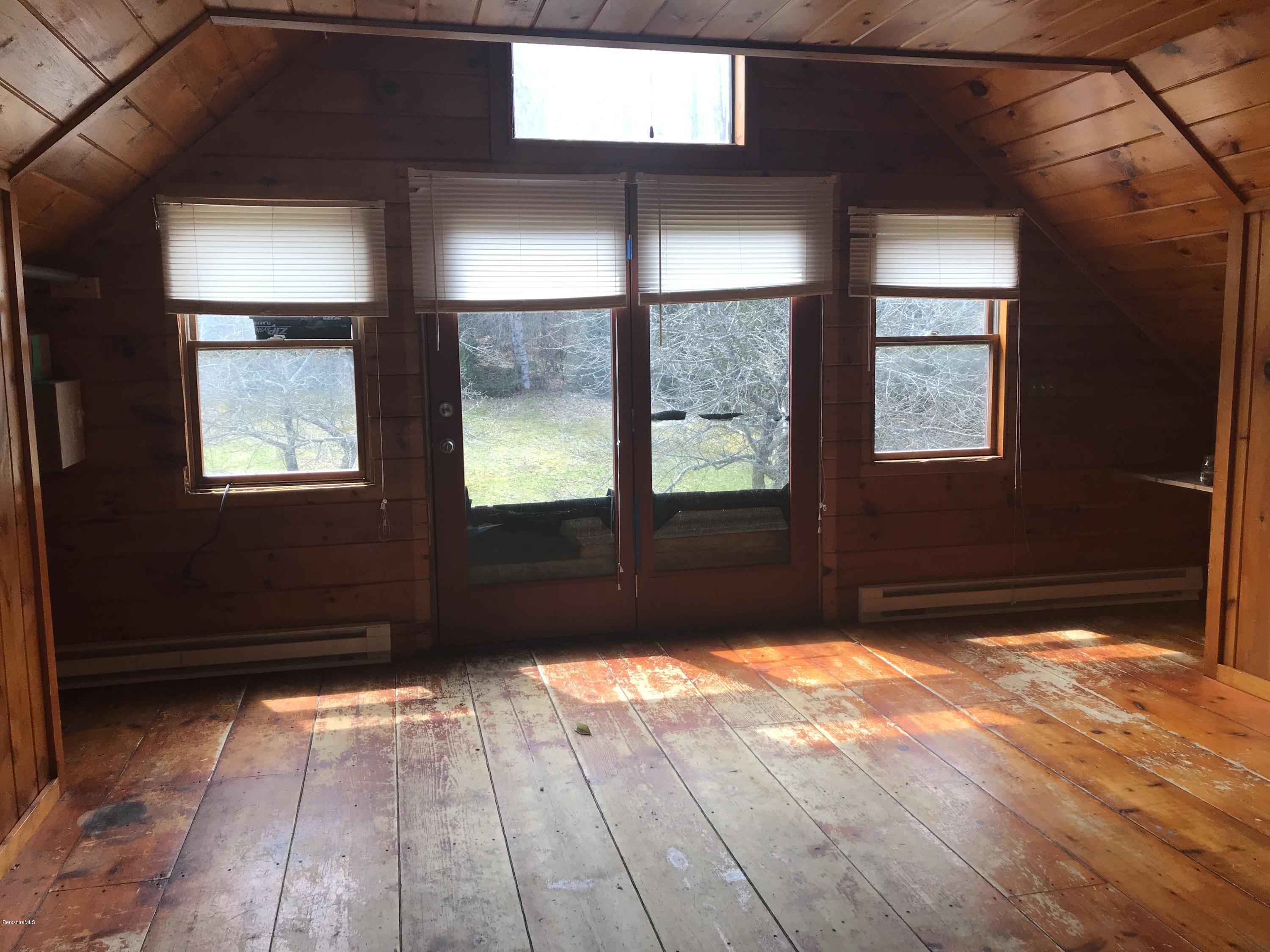 89 Hickingbotham Road Peru, MA 01235 - Photo 4 of 14 a view of a livingroom with wooden floor and a window