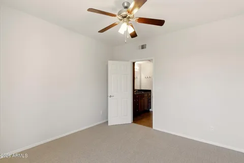 a view of a room with a ceiling fan and a ceiling fan