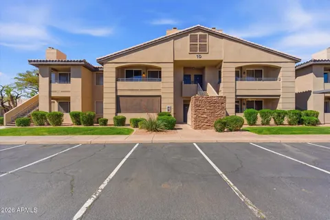 a front view of a house with a yard and a garage