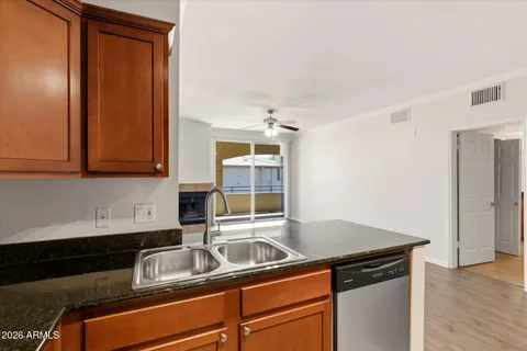 a kitchen with granite countertop a sink and a stove