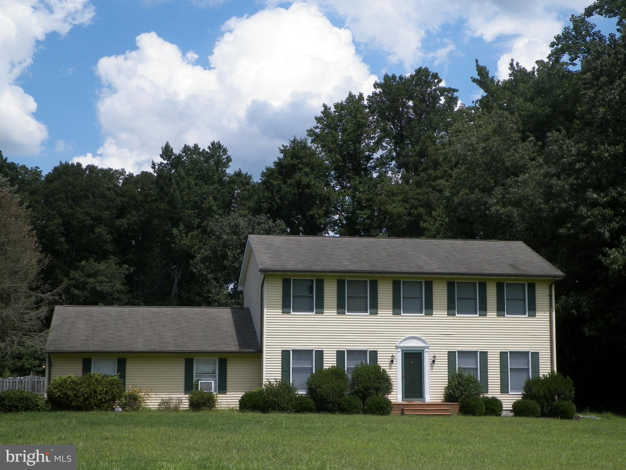 3151 Carroll Road Huntingtown, MD 20639 - Photo 1 of 30 a front view of a house with a garden