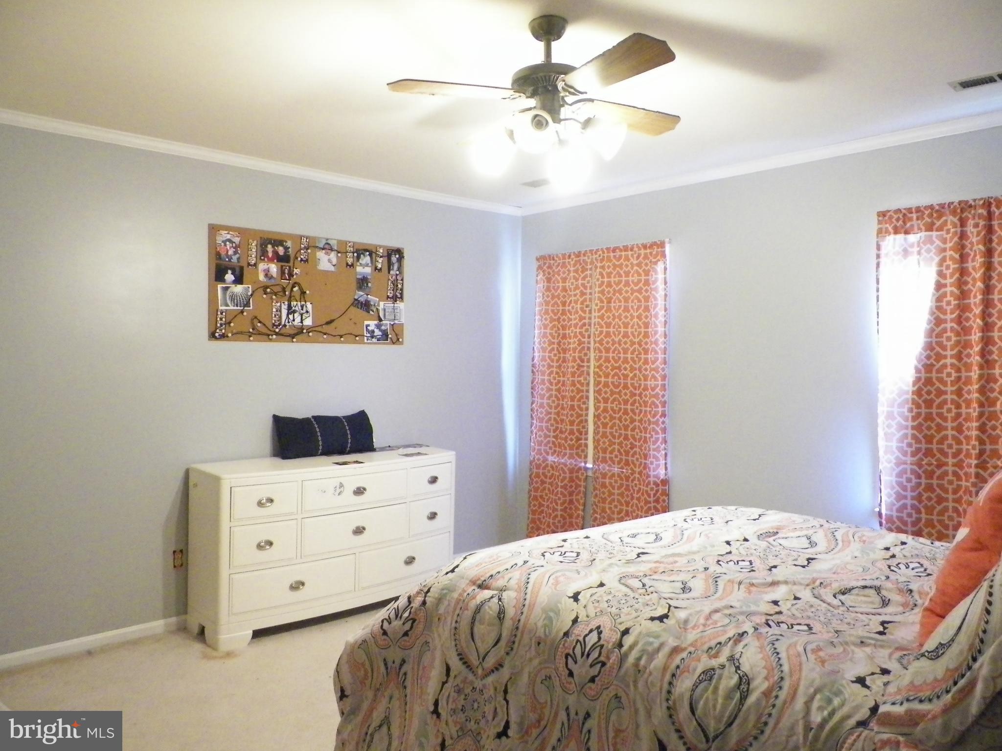 3151 Carroll Road Huntingtown, MD 20639 - Photo 13 of 30 a bedroom with a bed and a window