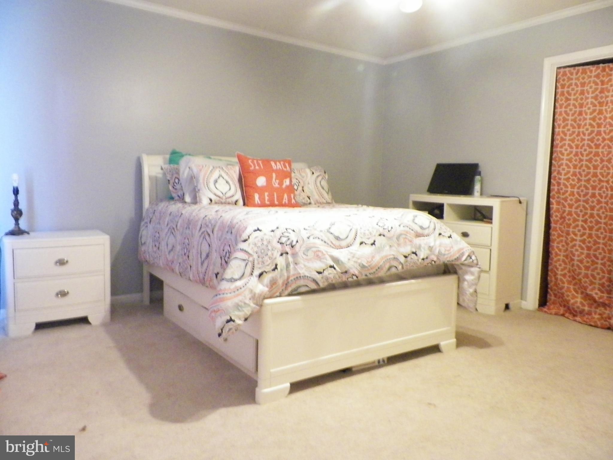 3151 Carroll Road Huntingtown, MD 20639 - Photo 27 of 30 a bedroom with a bed and a tv