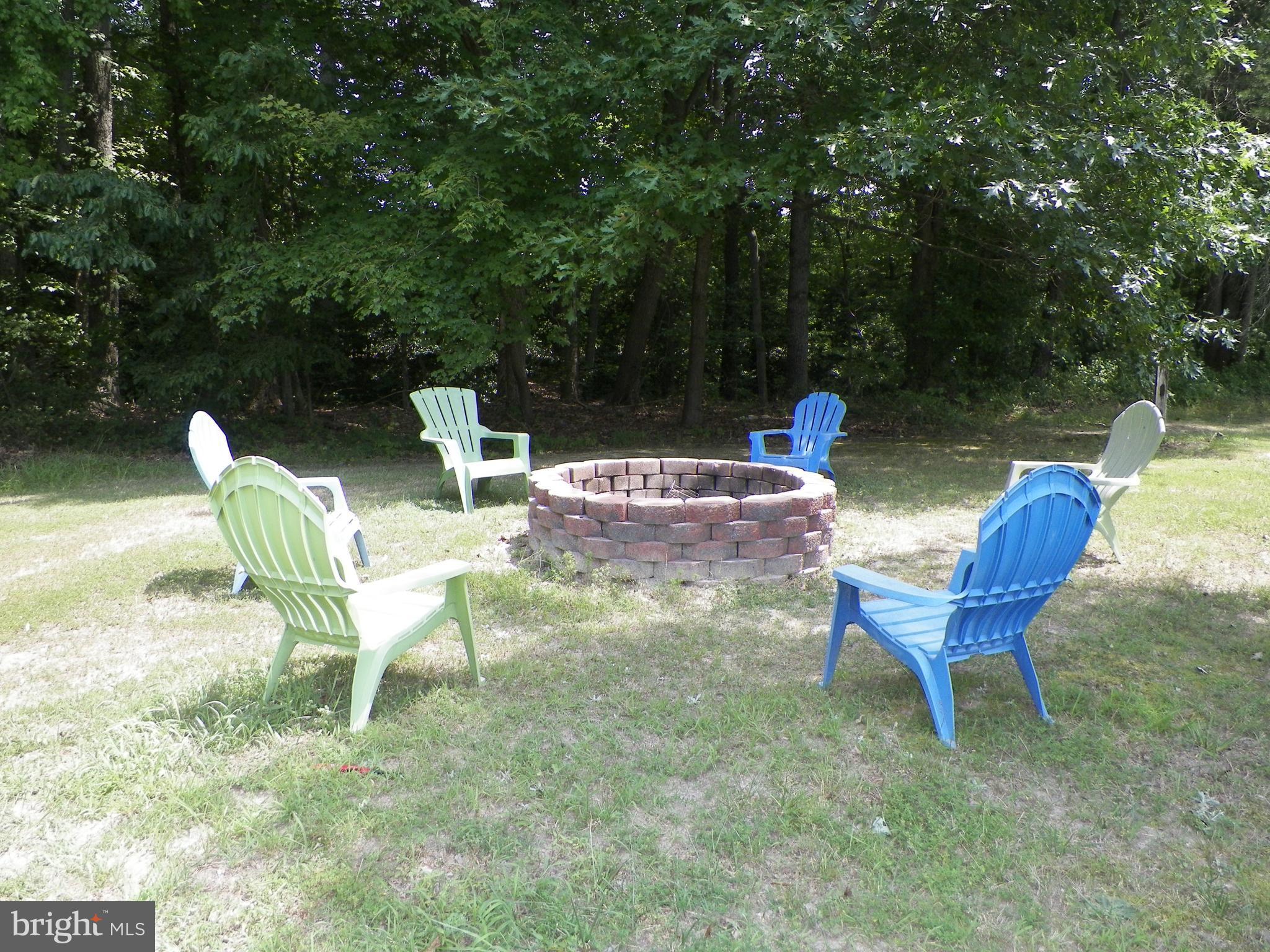 3151 Carroll Road Huntingtown, MD 20639 - Photo 6 of 30 a view of a chairs and table in the backyard