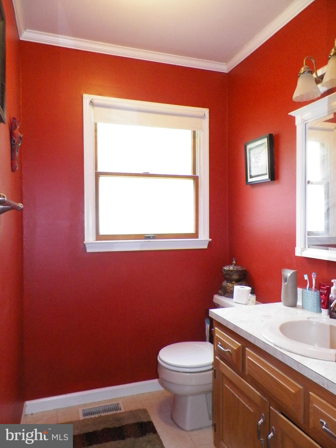 3151 Carroll Road Huntingtown, MD 20639 - Photo 9 of 30 a bathroom with a sink a toilet and a mirror