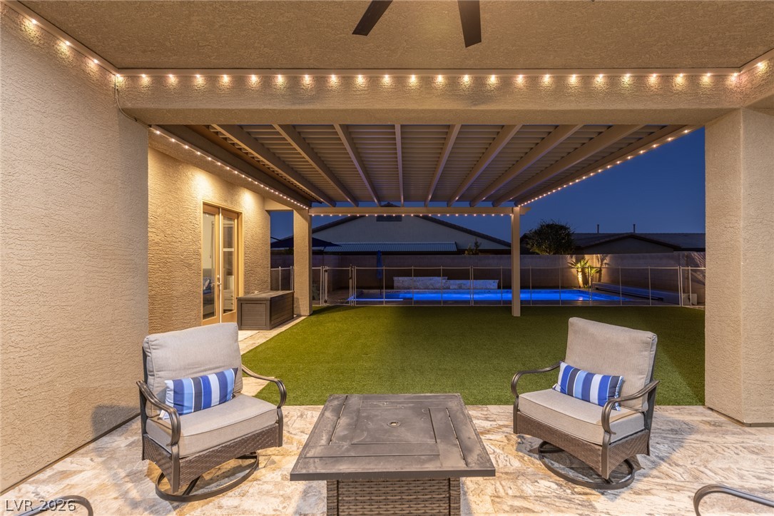 7036 Arabian Ridge Street Las Vegas, NV 89131 - Photo 53 of 64 Step outside to your private backyard oasis featuring a sparkling pool and spa with an automated cover, safety fence, a covered patio with extended pergolas for additional shade, a dedicated dog run, a freestanding BBQ, and permanent interchangeable lighting system.