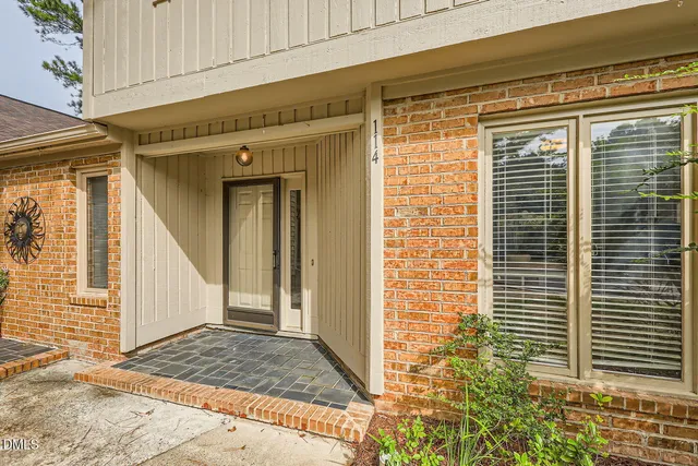 a view of a brick house with windows