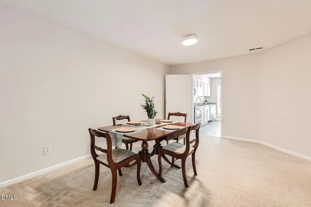 a kitchen with a sink a stove a refrigerator and white cabinets
