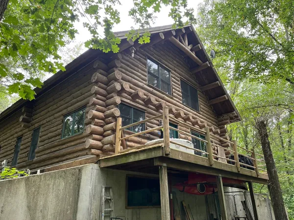 a view of a house with a large tree