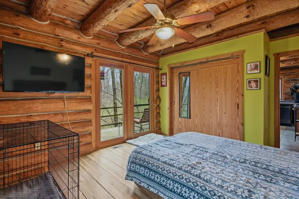 a bedroom with a bed and flat screen tv