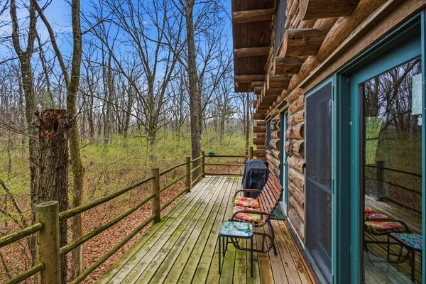 a view of balcony with wooden floor and seating space