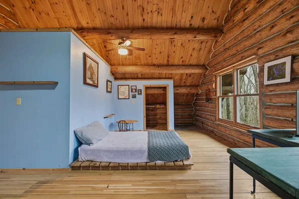 a bedroom with furniture and wooden floor