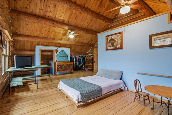 a bedroom with furniture and wooden floor