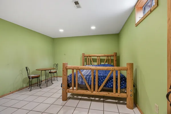 a bedroom with a bed and a table